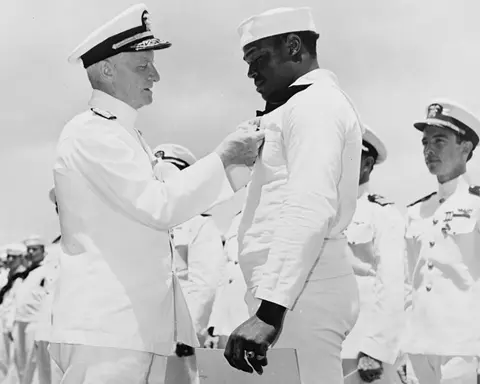 Doris (Dorie) Miller receiving the Navy Cross for heroism during World War II