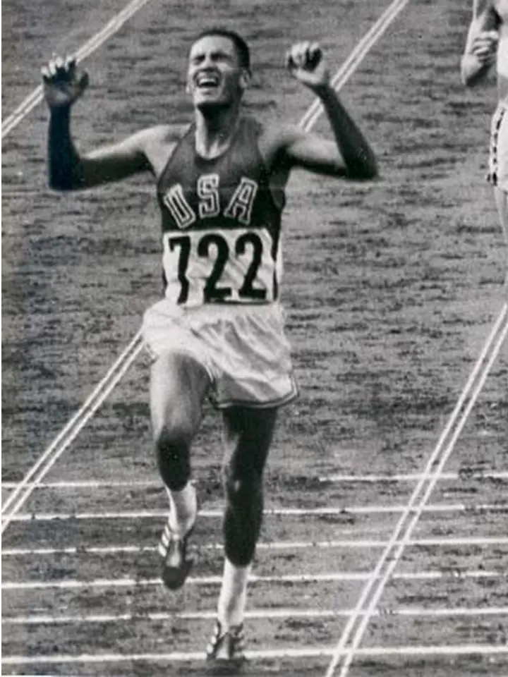 Billy Mills crossing the finish line at the 1964 Olympics