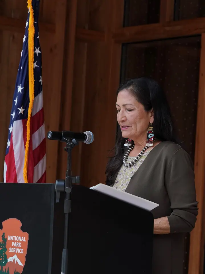 Deb Haaland speaking at a podium