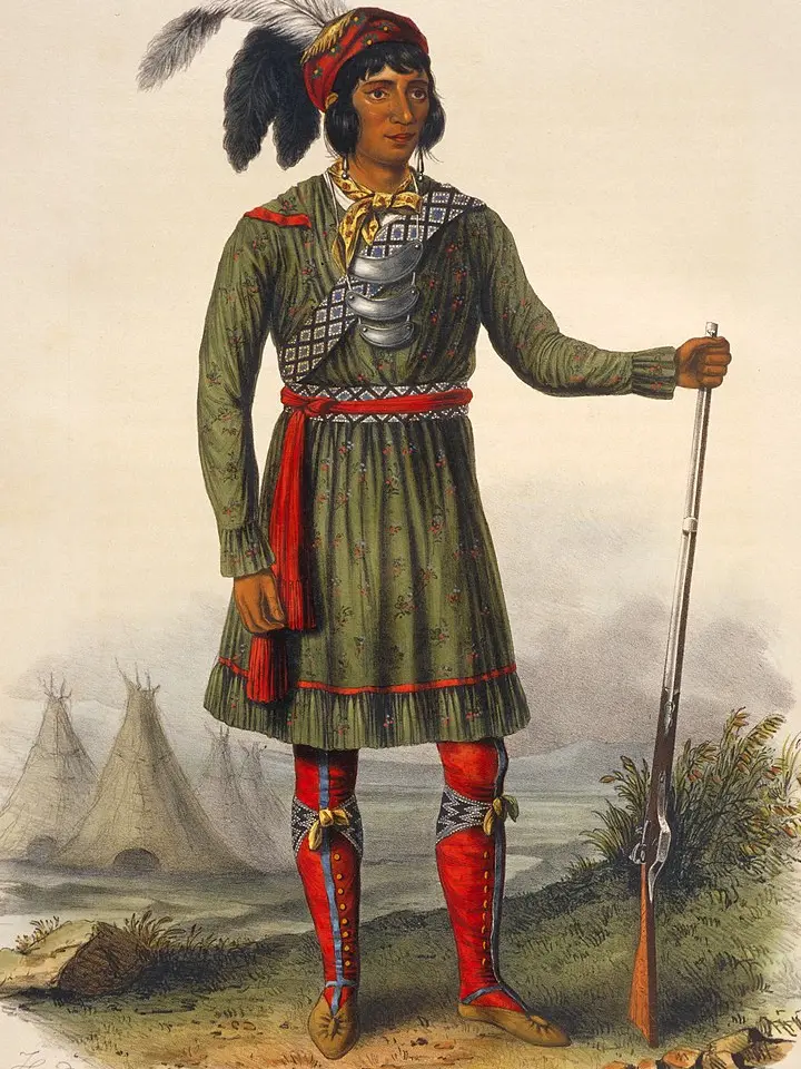 Osceola standing with a rifle