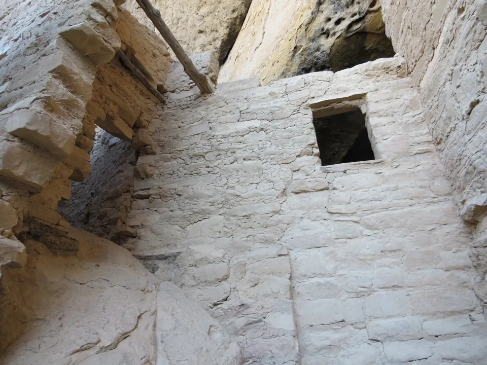 A small doorway in a stone wall inside a cliff dwelling