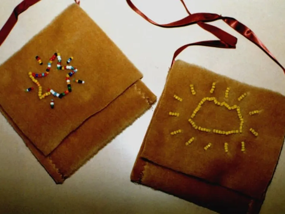 Two student-made suede bags decorated with beads
