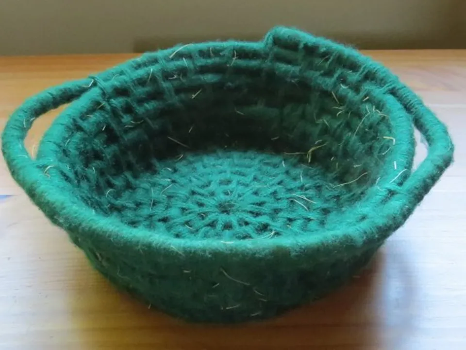 A green coiled basket made by a student
