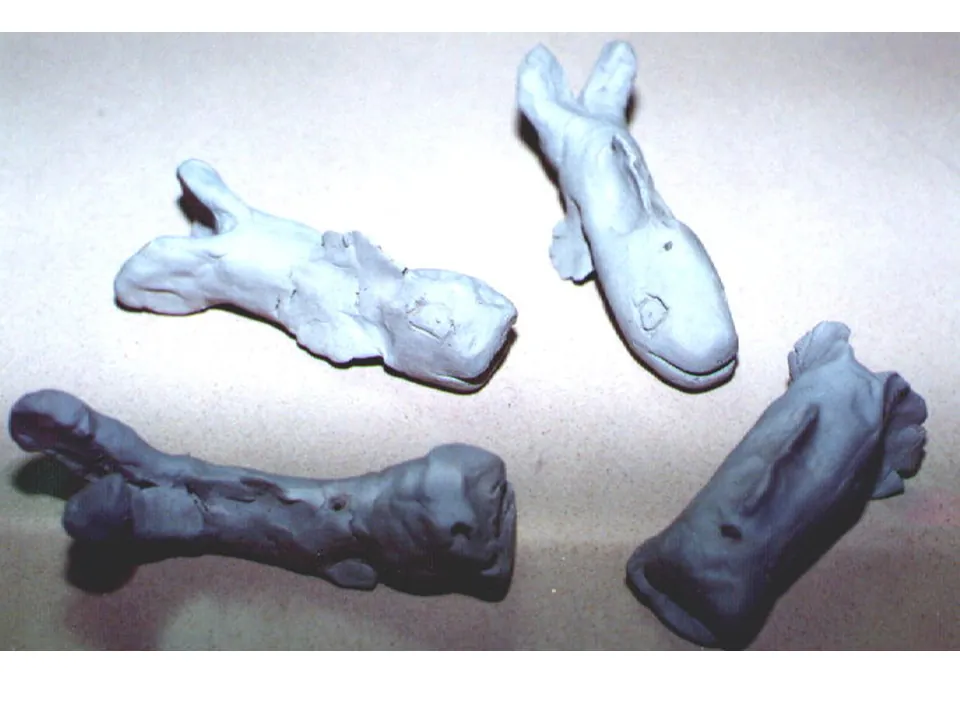 Four small clay whales made by students