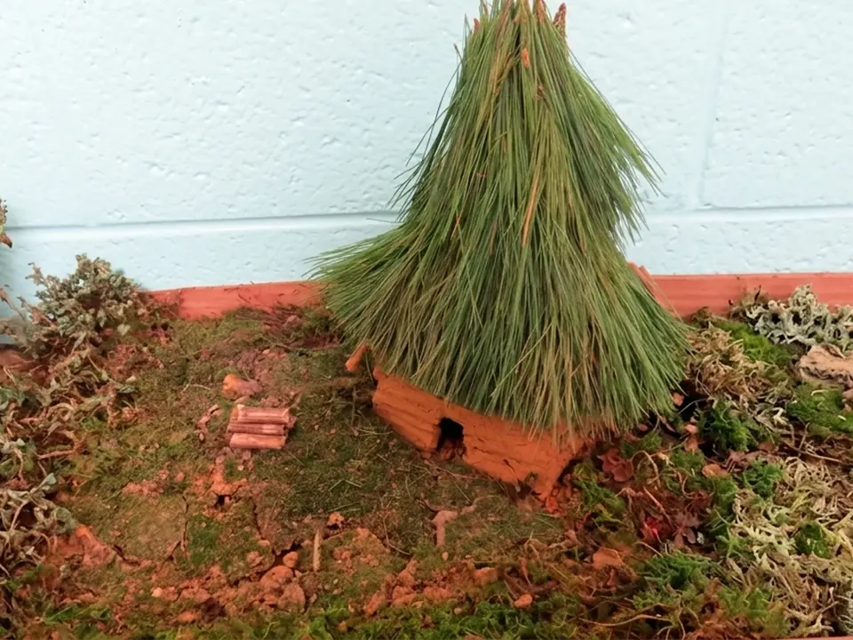 Student model of a round Cherokee winter house with a cone-shaped roof