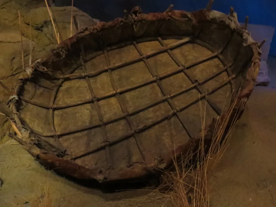 A round boat made of hide stretched over a wooden frame
