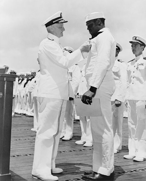 dmiral Chester W. Nimitz pins the Navy Cross on Doris Miller, 
Pearl Harbor, May 27, 1942