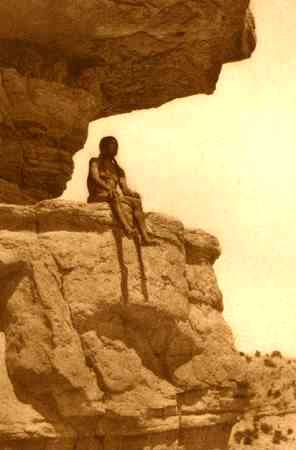 Apache on a high rock cliff