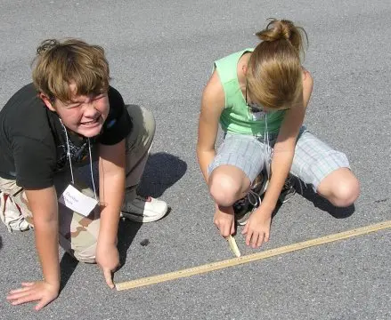Students folding paper airplanes
