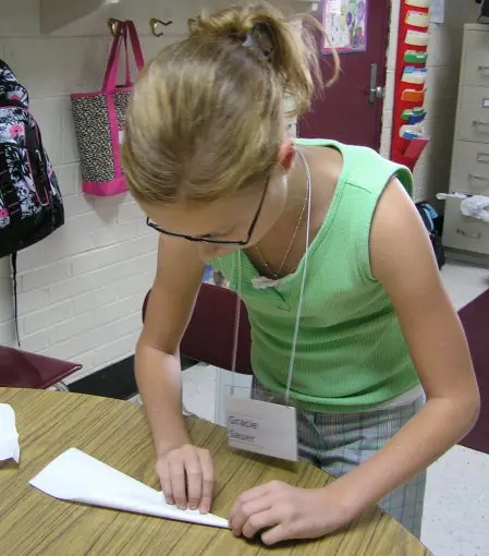 Students preparing paper airplane experiment