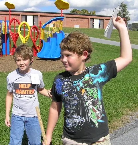 Students preparing to throw paper airplanes